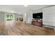 Bright living room with hardwood floors, built-in shelving, and a sliding door to the backyard at 2944 Braithwood Ne Ct, Atlanta, GA 30345