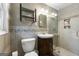 Updated bathroom with tiled walls, glass shower, and vanity with dark wood cabinet at 2944 Braithwood Ne Ct, Atlanta, GA 30345