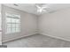 Cozy bedroom features neutral walls, ceiling fan, and plush gray carpeting at 8750 Redford Ln, Suwanee, GA 30024
