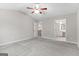 Well-lit, carpeted bedroom showing access to an en-suite bathroom and an upstairs hallway at 8750 Redford Ln, Suwanee, GA 30024