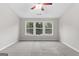 Spacious bedroom with carpet, a ceiling fan and multiple windows showing a lush green view at 8750 Redford Ln, Suwanee, GA 30024