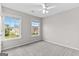 Neutral bedroom with carpet, two windows letting in light, and freshly painted walls at 8750 Redford Ln, Suwanee, GA 30024