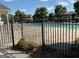 Fenced community pool area with plenty of lounge chairs for residents to enjoy at 8750 Redford Ln, Suwanee, GA 30024