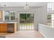 Sunny dining area features wood floors, backyard access, and large windows at 8750 Redford Ln, Suwanee, GA 30024