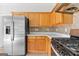 Efficient kitchen with stainless steel appliances, wooden cabinets and laminate floors for meal preparation at 8750 Redford Ln, Suwanee, GA 30024