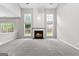 Open-concept living room featuring a cozy fireplace and ample natural light at 8750 Redford Ln, Suwanee, GA 30024