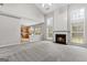 Spacious living room with a fireplace and high ceilings and entry to kitchen at 8750 Redford Ln, Suwanee, GA 30024