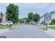 A wide shot of the street, with well-maintained lawns, cars parked and mature trees at 8750 Redford Ln, Suwanee, GA 30024