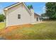 Exterior view of backyard featuring a home with a patio and a shed with a partially wooded lot at 501 Llewellyn Ct, Jenkinsburg, GA 30234