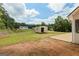 Expansive backyard featuring a storage shed on a bright and sunny day, perfect for outdoor activities at 501 Llewellyn Ct, Jenkinsburg, GA 30234