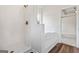 A bright bathroom featuring a shower, soaking tub and wood floors at 501 Llewellyn Ct, Jenkinsburg, GA 30234