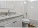 This bathroom features a granite countertop, white cabinetry, and shower over tub at 501 Llewellyn Ct, Jenkinsburg, GA 30234