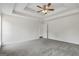 A bright bedroom with neutral carpet, ceiling fan and an ensuite bath at 501 Llewellyn Ct, Jenkinsburg, GA 30234