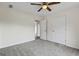 Bedroom with neutral carpet, ceiling fan, and door to hallway at 501 Llewellyn Ct, Jenkinsburg, GA 30234