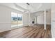 Dining area features wood floors, a modern light fixture, and large windows, creating a warm ambiance at 501 Llewellyn Ct, Jenkinsburg, GA 30234