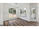 Bright dining room area with wood floors and modern light fixture, connecting seamlessly to outdoor views at 501 Llewellyn Ct, Jenkinsburg, GA 30234