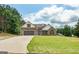 Charming brick home with a well-manicured lawn, attached two car garage and solar panels on the roof at 501 Llewellyn Ct, Jenkinsburg, GA 30234