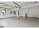 Interior view of garage with epoxy floor and two windows at 501 Llewellyn Ct, Jenkinsburg, GA 30234