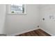 A bright laundry room with wood floors and a large window for natural light at 501 Llewellyn Ct, Jenkinsburg, GA 30234