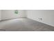 This room offers neutral carpet and a window at 501 Llewellyn Ct, Jenkinsburg, GA 30234