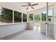 Bright screened porch features a ceiling fan, neutral paint, and views of the surrounding landscape at 501 Llewellyn Ct, Jenkinsburg, GA 30234