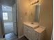 Bathroom featuring a white vanity with countertop space and a decorative light fixture at 756 Glenshire Ct, Riverdale, GA 30274