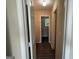Hallway with wood floors, light walls, and a view into the bathroom at 756 Glenshire Ct, Riverdale, GA 30274