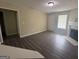 Open living room featuring wood floors, fireplace, and access to the front door at 756 Glenshire Ct, Riverdale, GA 30274