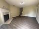 Open living room with hardwood floors, a fireplace, and staircase at 756 Glenshire Ct, Riverdale, GA 30274
