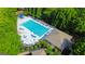 Aerial view of community pool with lounge chairs and shaded seating areas amidst lush greenery at 150 Campaign Trl, Fayetteville, GA 30214