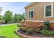 Beautiful backyard showcasing an outdoor stone fireplace, a half wall of stone, and a well-manicured lawn at 150 Campaign Trl, Fayetteville, GA 30214