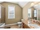 Well-lit bathroom featuring a granite countertop, wooden cabinets, tiled floors, and a shower/tub combo at 150 Campaign Trl, Fayetteville, GA 30214