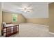 Cozy bedroom with carpeted floor, a bed and a window letting in natural light at 150 Campaign Trl, Fayetteville, GA 30214