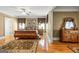 Cozy bedroom with a wooden sleigh bed, decorative rug, dresser, and windows with elegant valances at 150 Campaign Trl, Fayetteville, GA 30214