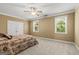 Comfortable bedroom with carpeted floor, large windows, a ceiling fan and double door closet at 150 Campaign Trl, Fayetteville, GA 30214