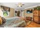 Comfortable bedroom with wood floors, a large bed, television, and stylish wooden furnishings at 150 Campaign Trl, Fayetteville, GA 30214