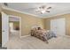 Bright bedroom with carpeted floor, ceiling fan, a bed and natural light from two windows at 150 Campaign Trl, Fayetteville, GA 30214