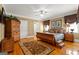 Bright bedroom with a wooden sleigh bed, windows with valances, and stylish wooden furnishings at 150 Campaign Trl, Fayetteville, GA 30214