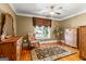 Charming bedroom featuring a decorative area rug, large window, and classic wooden dressers and furnishings at 150 Campaign Trl, Fayetteville, GA 30214