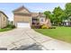 This home features a long driveway, lush grass and landscaping, and a backyard stone fireplace at 150 Campaign Trl, Fayetteville, GA 30214