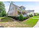 Attractive home featuring an expansive lawn with beautiful plantings and an inviting covered porch on the side at 150 Campaign Trl, Fayetteville, GA 30214