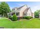 Attractive home featuring an expansive lawn with beautiful plantings and an inviting covered porch on the side at 150 Campaign Trl, Fayetteville, GA 30214