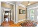 Elegant foyer featuring hardwood floors, an ornate rug, and an arched entrance with leaded glass doors and sidelights at 150 Campaign Trl, Fayetteville, GA 30214