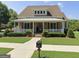 Charming home featuring a welcoming front porch and meticulously landscaped lawn and beautiful plantings at 150 Campaign Trl, Fayetteville, GA 30214