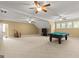 Spacious game room with a pool table, carpeted floor, and multiple windows for natural light at 150 Campaign Trl, Fayetteville, GA 30214