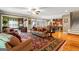Open-concept living room with hardwood floors and a view of the kitchen at 150 Campaign Trl, Fayetteville, GA 30214