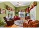 Cozy room featuring green walls, a ceiling fan, and a round rug at 150 Campaign Trl, Fayetteville, GA 30214