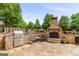 This large outdoor patio has a stone fireplace, a built-in grilling area, and a beautiful setting for relaxation at 150 Campaign Trl, Fayetteville, GA 30214