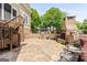 Cozy outdoor patio featuring a stone fireplace, built-in grill, and ample seating for entertaining guests at 150 Campaign Trl, Fayetteville, GA 30214