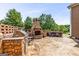 A spacious outdoor patio features a stone fireplace, built-in grilling area, and plenty of room to entertain at 150 Campaign Trl, Fayetteville, GA 30214